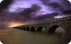 long_stone_bridge_over_water-wide